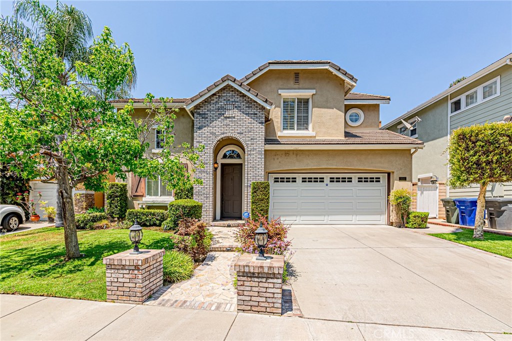 106 Lakeside Drive Buena Park, CA 90621 - Photo 1 of 3 a front view of a house with a garden