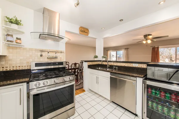 a kitchen with stainless steel appliances granite countertop a stove sink and cabinets