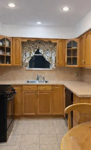 a kitchen with stainless steel appliances granite countertop a sink and a stove