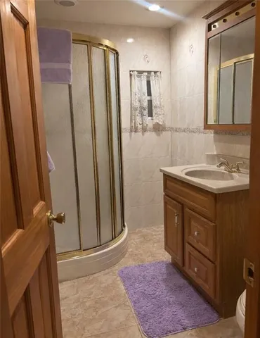 a bathroom with a sink a mirror and a shower