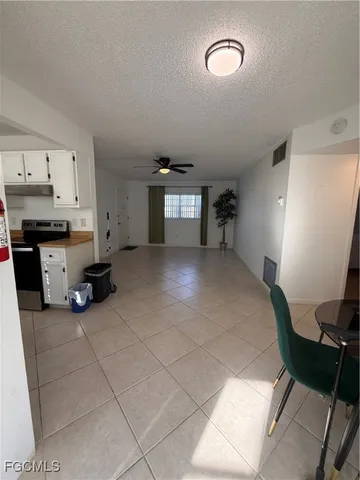 a view of a livingroom with furniture and a window
