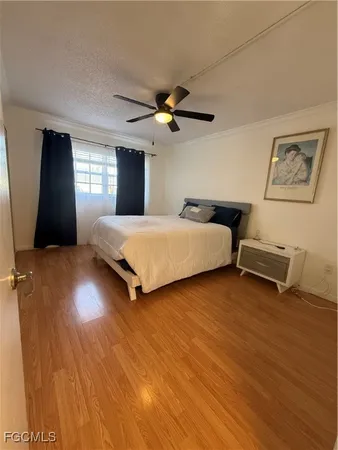 a bedroom with two beds and a ceiling fan