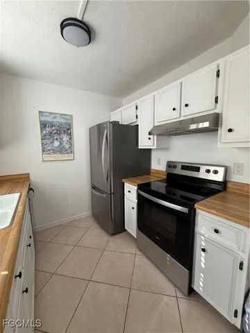 a kitchen with stainless steel appliances a refrigerator a stove a sink and a stove