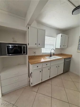 a kitchen with cabinets and appliances
