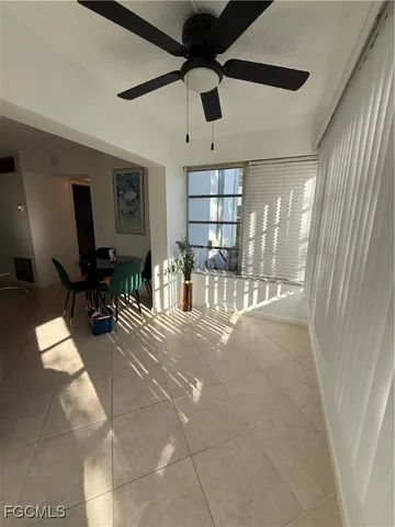 a lobby with furniture and a ceiling fan