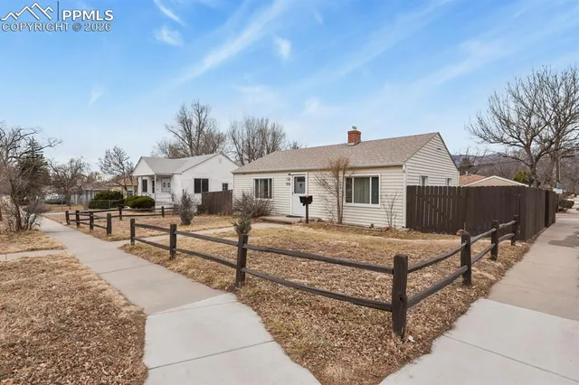 a view of a house with wooden deck and sitting area