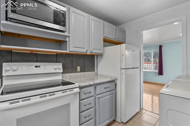a kitchen with appliances and cabinets