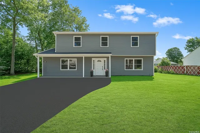 a front view of house with yard and green space
