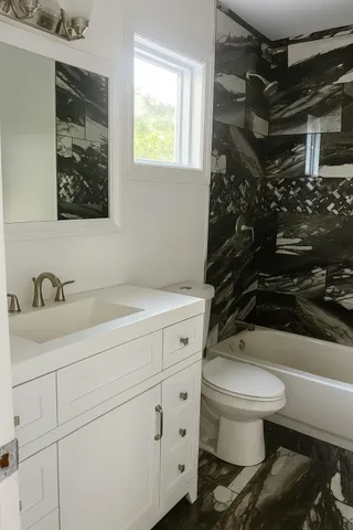 a bathroom with a sink toilet and shower