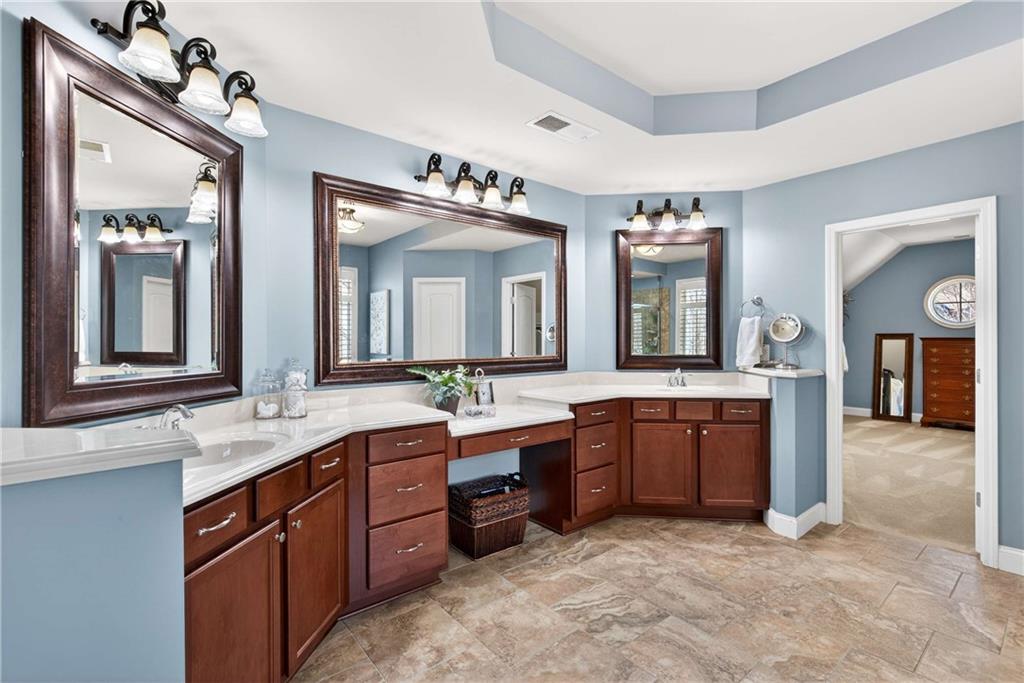 340 Scott Farm Drive Powder Springs, GA 30127 - Photo 28 of 59 a spacious bathroom with a granite countertop sink and a mirror