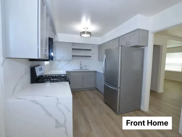 a kitchen with granite countertop a stove and a microwave