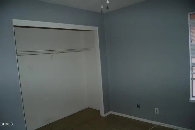 a bathroom with a granite countertop toilet a sink and shower