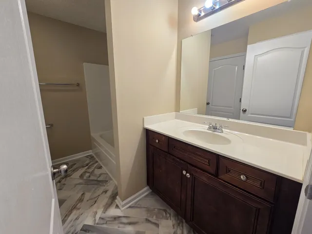 a bathroom with a sink a toilet and a mirror