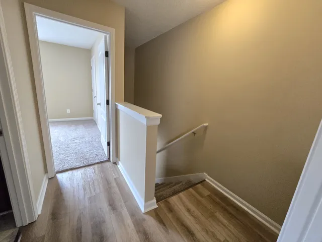 a view of a room with wooden floor