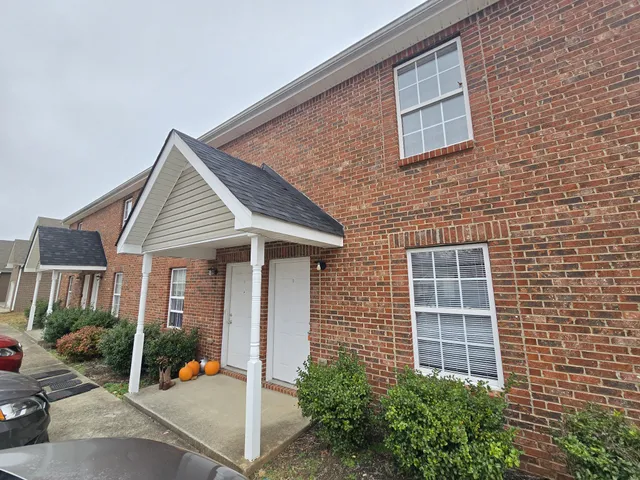 a view of a house with backyard porch and sitting area
