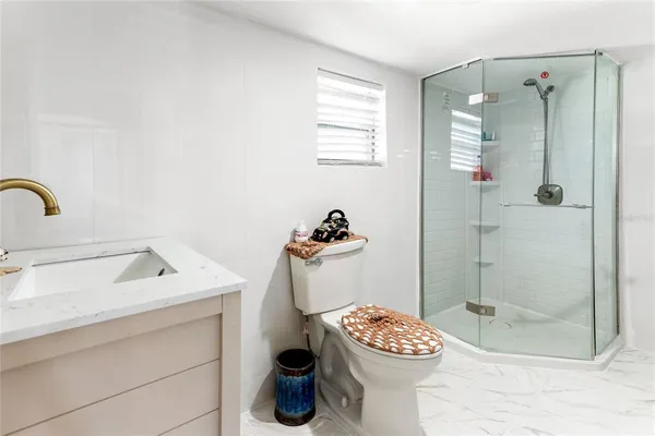 a bathroom with a sink toilet and shower
