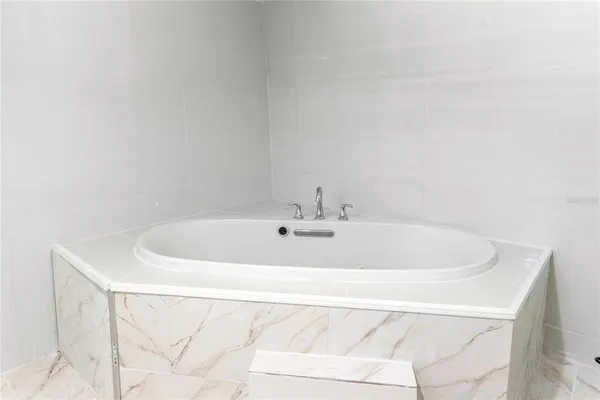 a white bath tub sitting in a bathroom