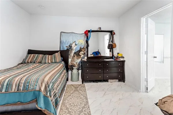 a bedroom with a bed and a dresser