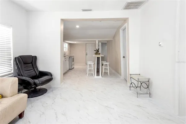 a living room with furniture and a dining table