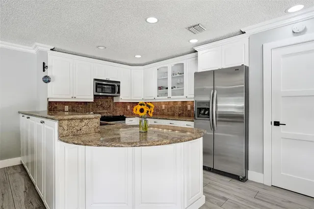 a living room with furniture and kitchen view