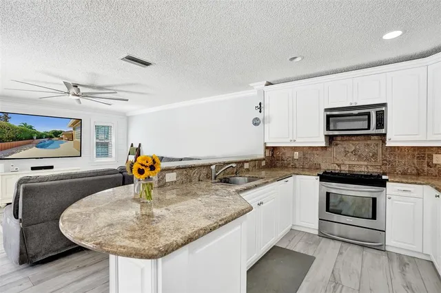 a living room with furniture ceiling fan and a window