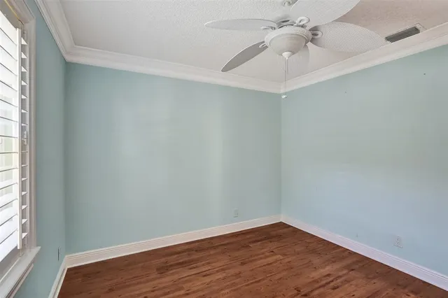 an aerial view of a residential houses with outdoor space and trees