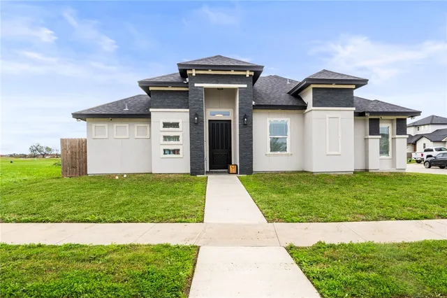 front view of a house with a yard