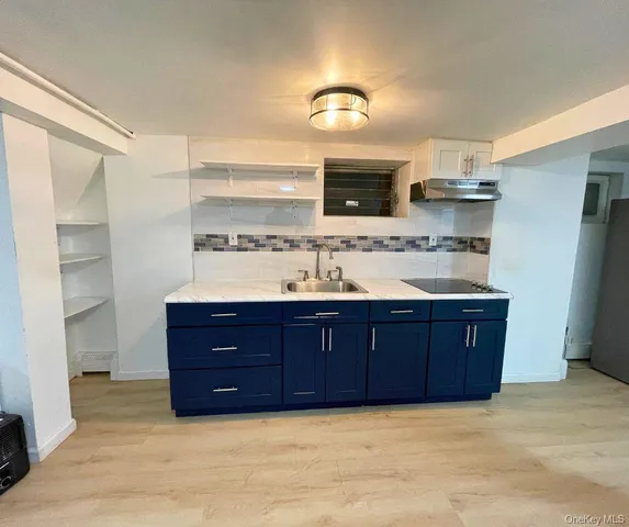 a bathroom with a granite countertop double vanity sink and mirror