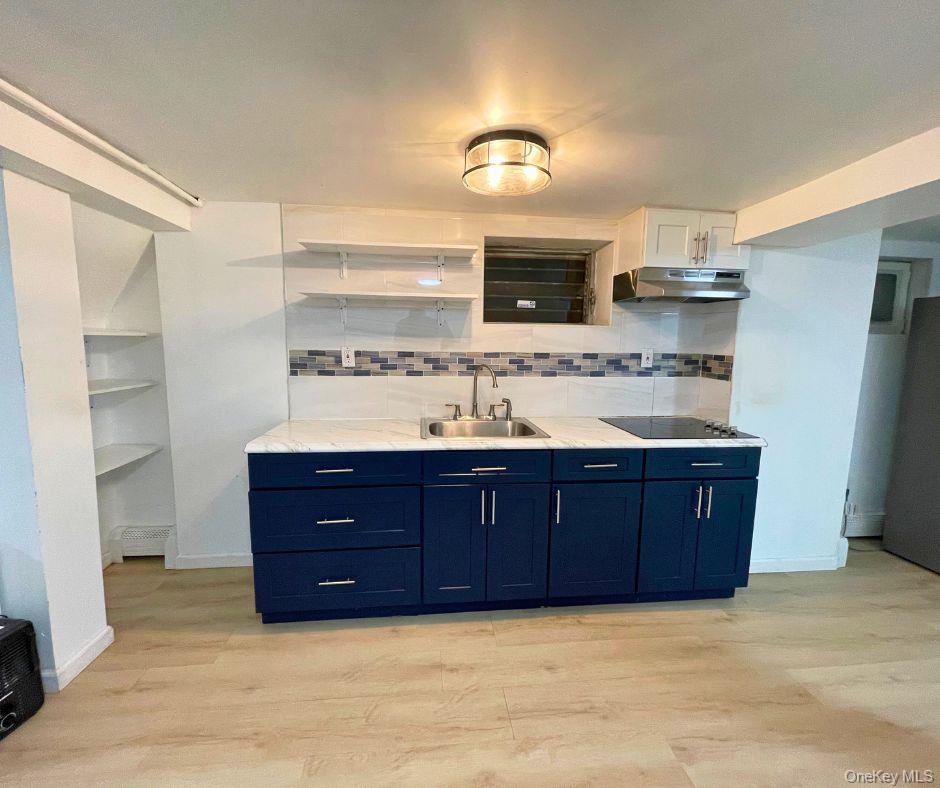 a bathroom with a granite countertop double vanity sink and mirror