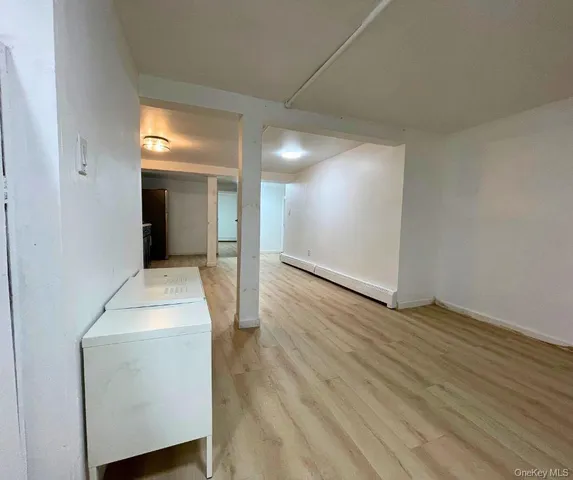 an entryway and a room with wooden floor