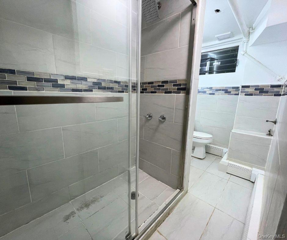 113-33 204th Street, Unit 3 Queens, NY 11412 - Photo 8 of 8 a bathroom with a shower and a toilet
