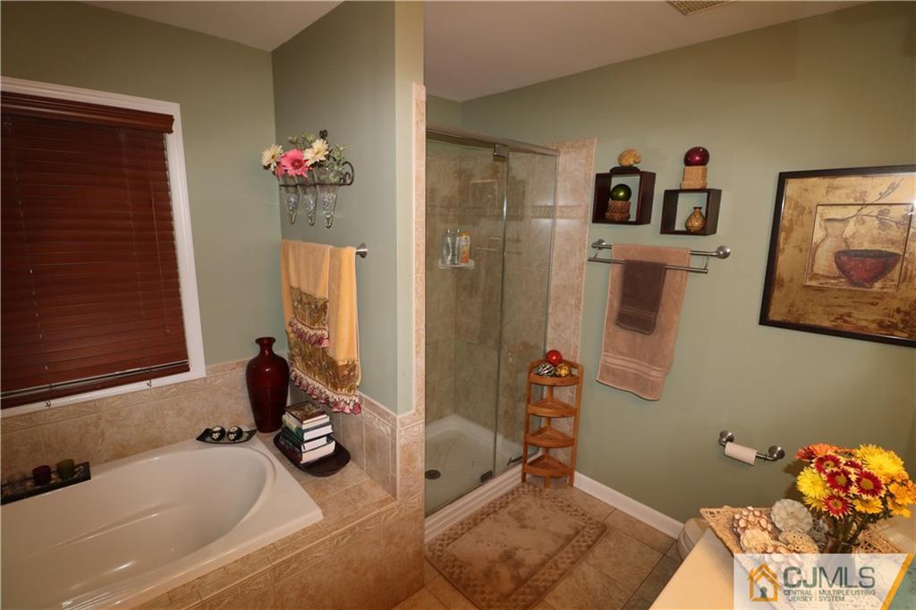 70 Willow Road Metuchen, NJ 08840 - Photo 14 of 25 a bath room with a sink and a mirror