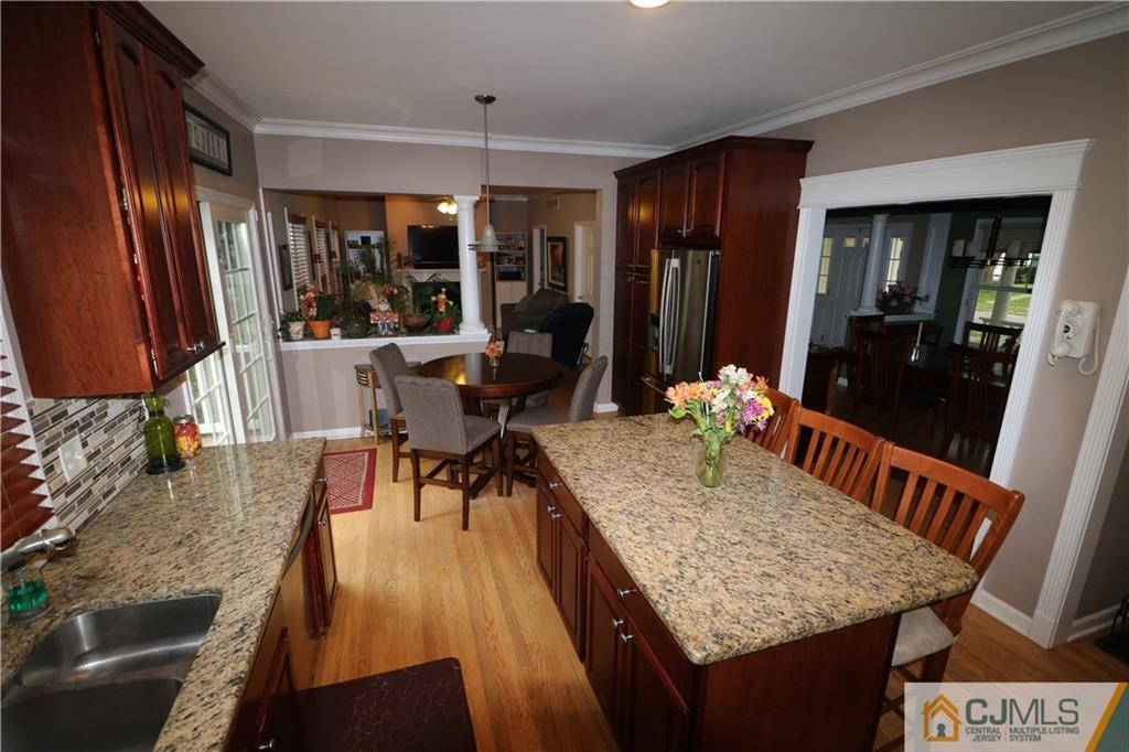 70 Willow Road Metuchen, NJ 08840 - Photo 8 of 25 a dining room with stainless steel appliances granite countertop furniture wooden floor and a kitchen view