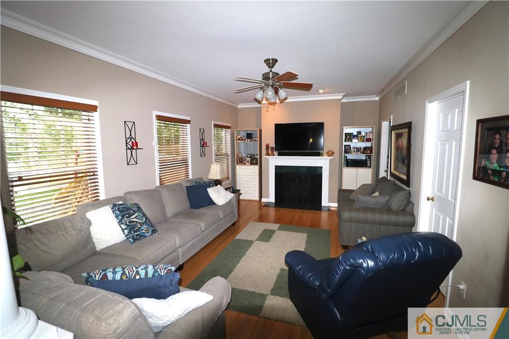 70 Willow Road Metuchen, NJ 08840 - Photo 9 of 25 a living room with furniture a flat screen tv and a window