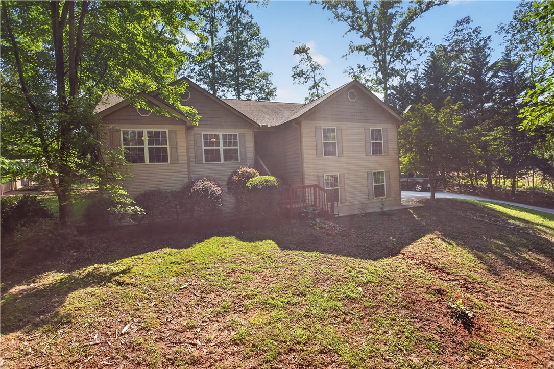 151 Towne Creek Trail Anderson, SC 29621 - Photo 36 of 49 A well-maintained home with siding and shutters offers a natural, wooded setting and a gently sloped yard.