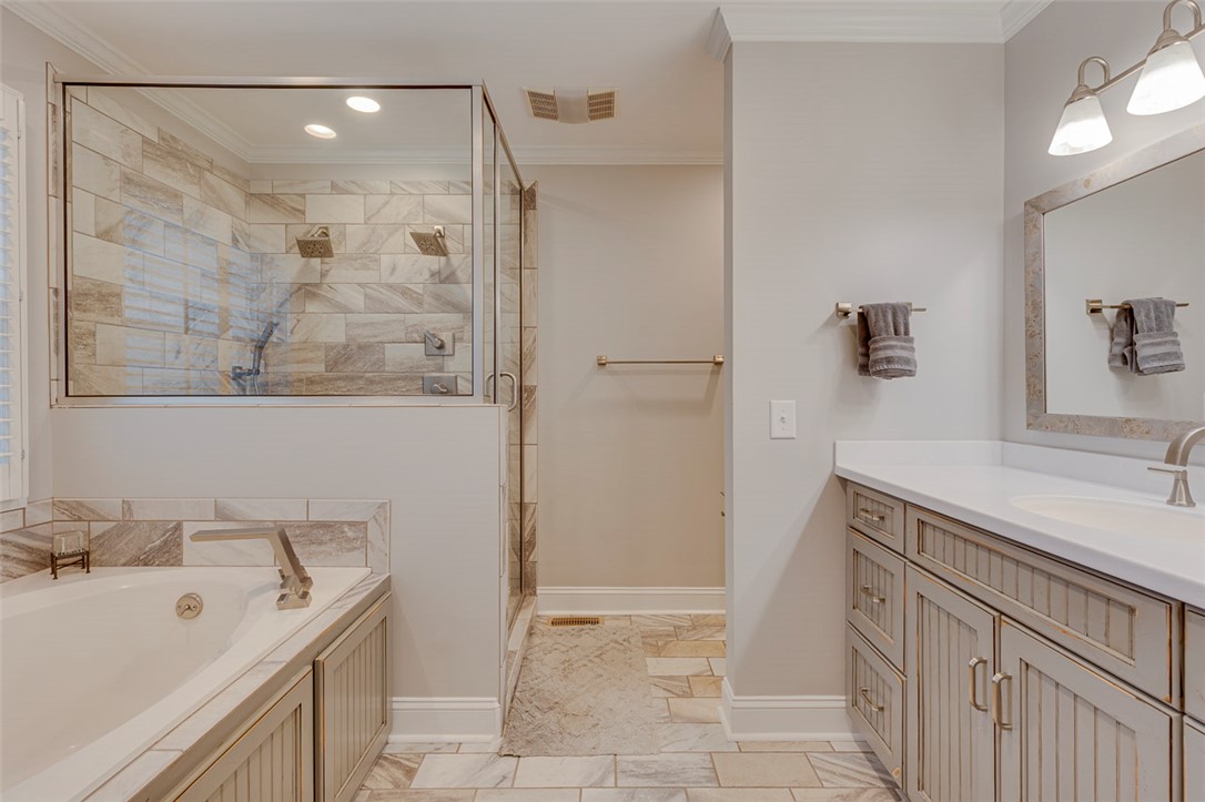 302 Wild Rice Drive Simpsonville, SC 29681 - Photo 25 of 44 Custom cabinetry and tiled finishes complement the built-in soaking tub and glass-enclosed shower.