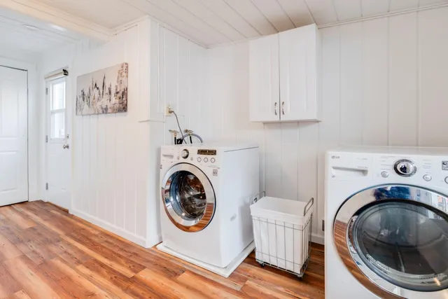 a utility room with sink dryer and washer