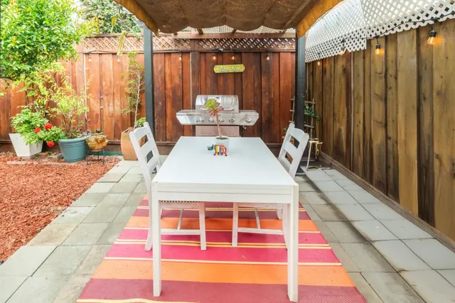a balcony with table and chairs