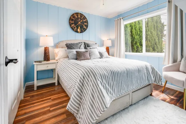 a bedroom with a bed and a lamp next to a window