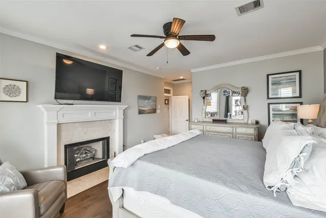 a spacious bedroom with a bed a couch and a flat screen tv