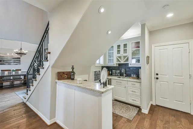 a kitchen with cabinets and wooden floor