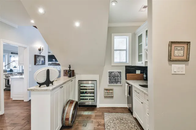 a kitchen with stainless steel appliances a stove top oven a sink a refrigerator and cabinets