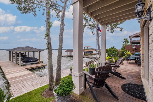 a view of a porch with furniture and a yard