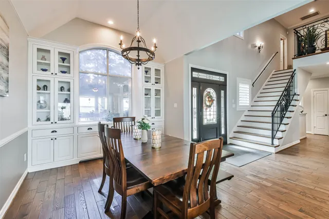 a view of a dining room with furniture wooden floor and chandelier
