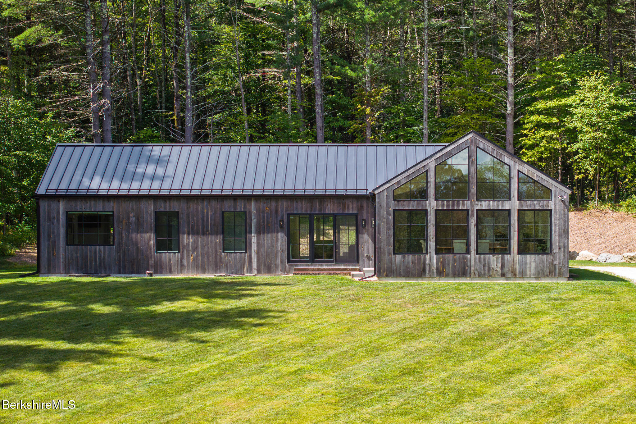 a view of a house with a yard and sitting area