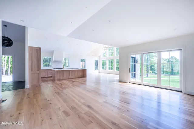 a view of a kitchen with wooden floor and a window