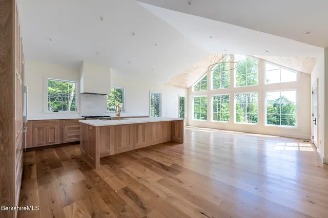a kitchen with kitchen island a sink and wooden floors