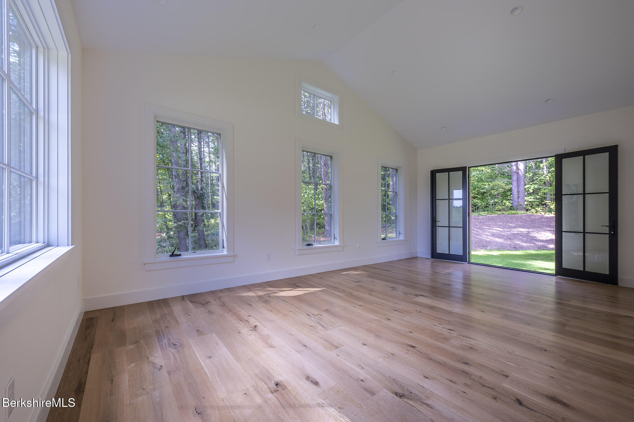 414 South Undermountain Road Sheffield, MA 01257 - Photo 20 of 37 an empty room with wooden floor and windows