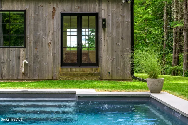 a living room with a kitchen island wooden floor and window