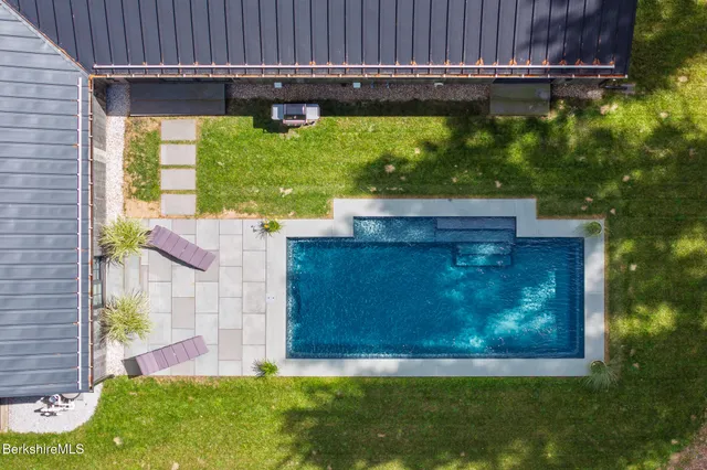 a view of backyard with a tub and trees
